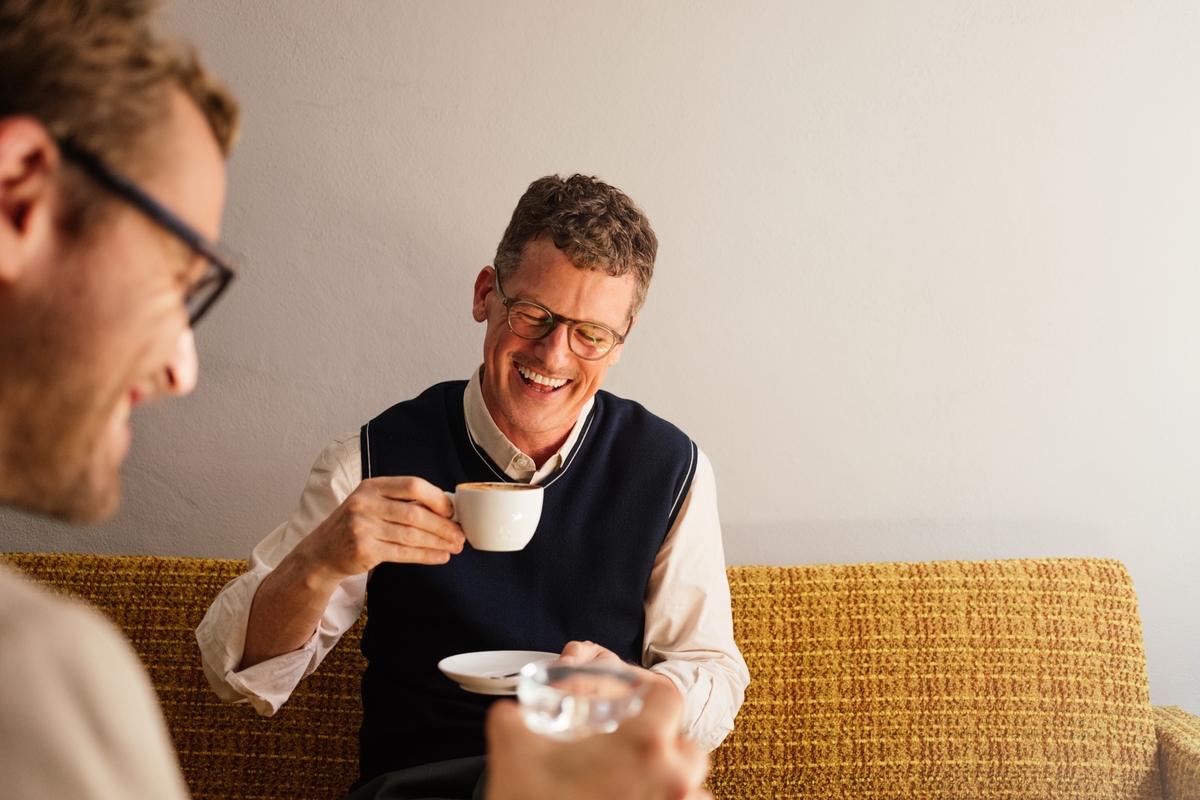 People laughing over a coffee interview